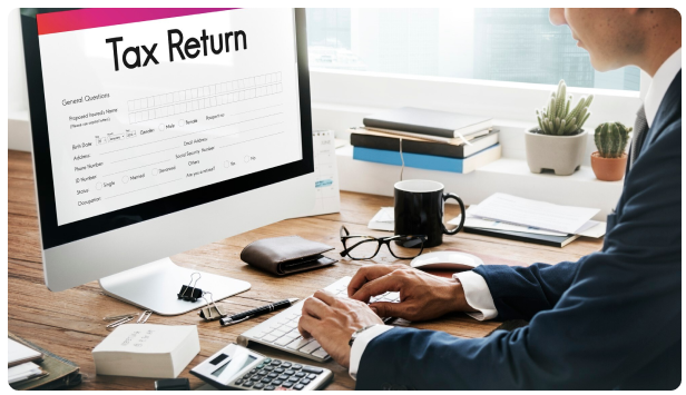 Businessperson filling out a tax return form on a computer